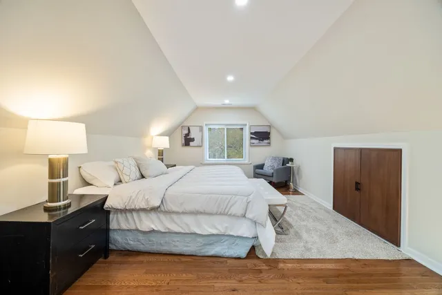 a bedroom with a bed and a lamp