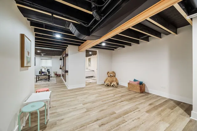 a room with wooden floor and gym equipment