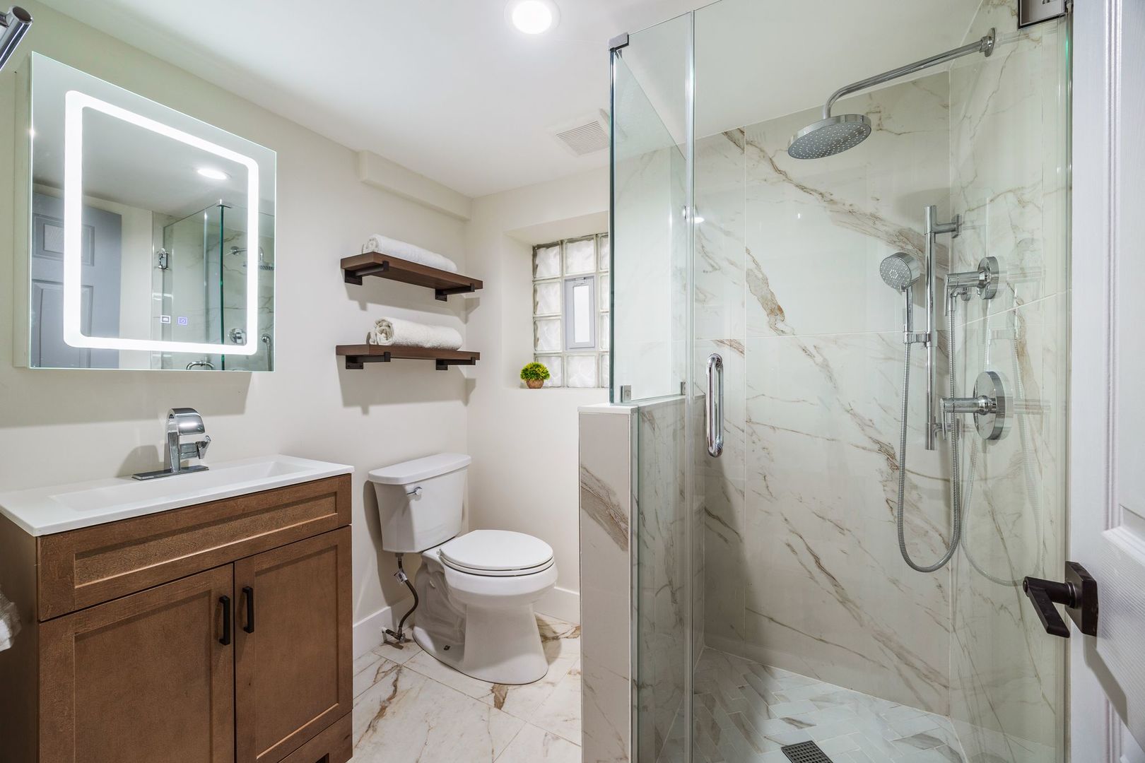 4143 North Drake Avenue Chicago, IL 60618 - Photo 33 of 40 a bathroom with a sink toilet and shower