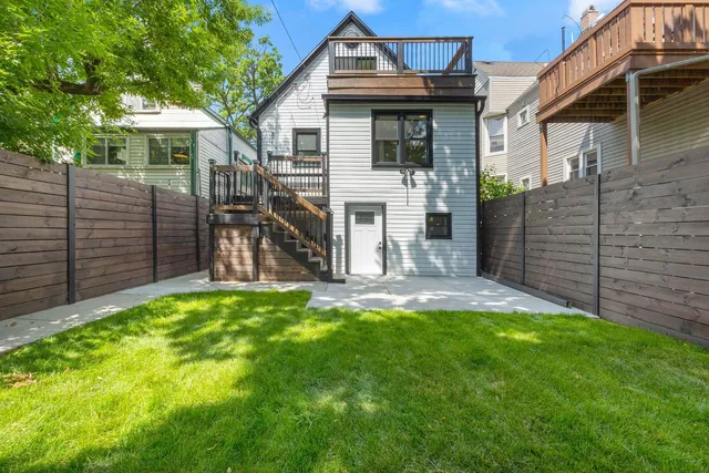 a view of backyard of house with green space