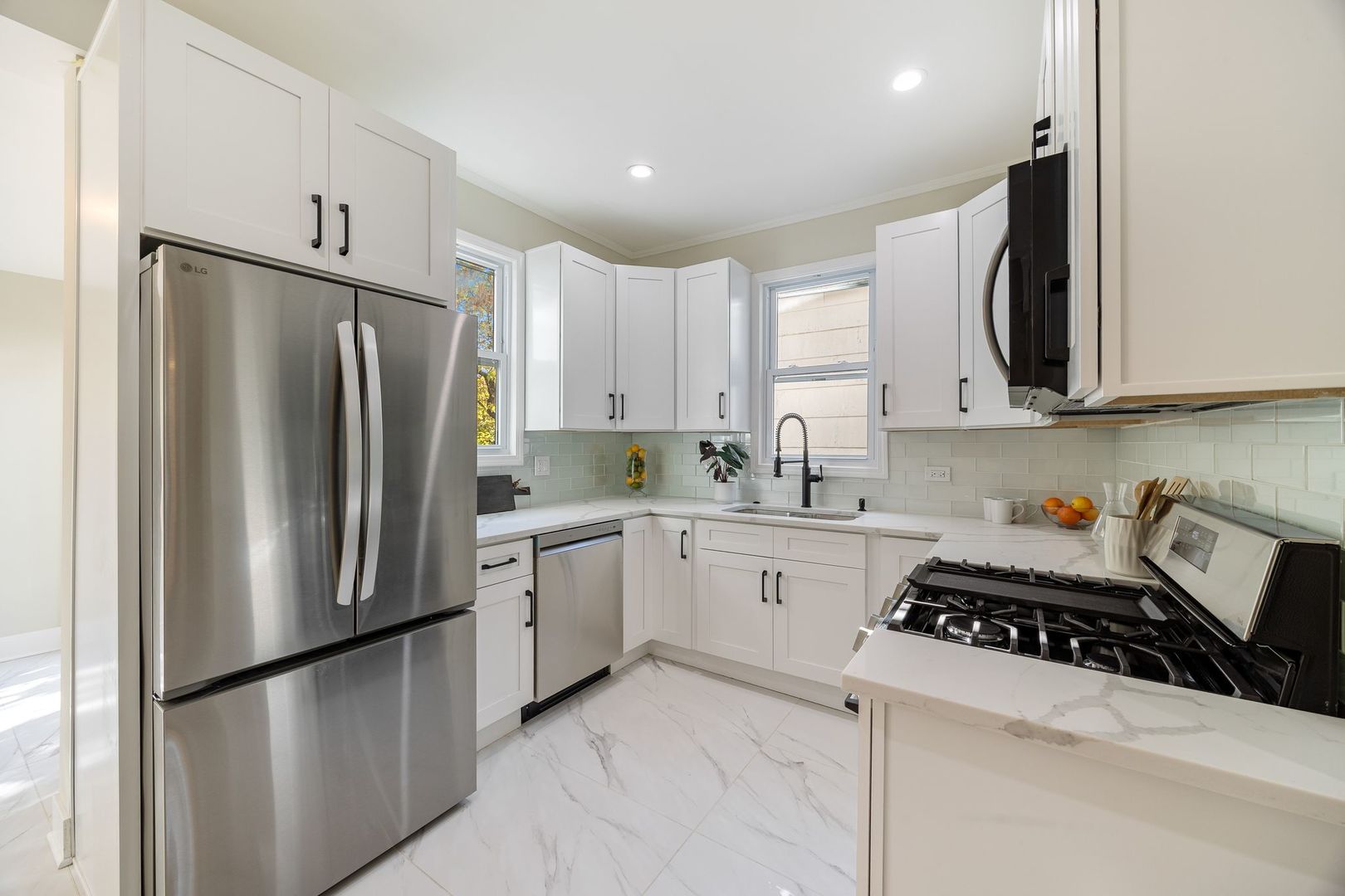 4143 North Drake Avenue Chicago, IL 60618 - Photo 9 of 40 a kitchen with stainless steel appliances granite countertop a refrigerator sink and microwave