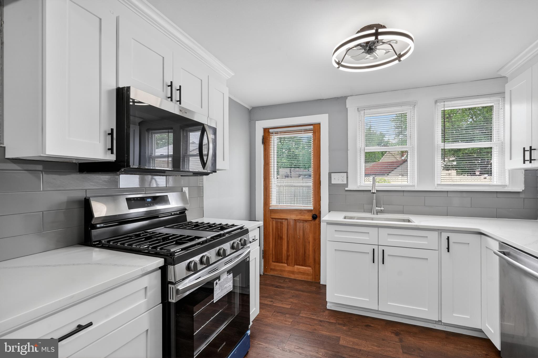 223 Noreg Place Brooklawn, NJ 08030 - Photo 17 of 36 a kitchen with cabinets appliances and a window