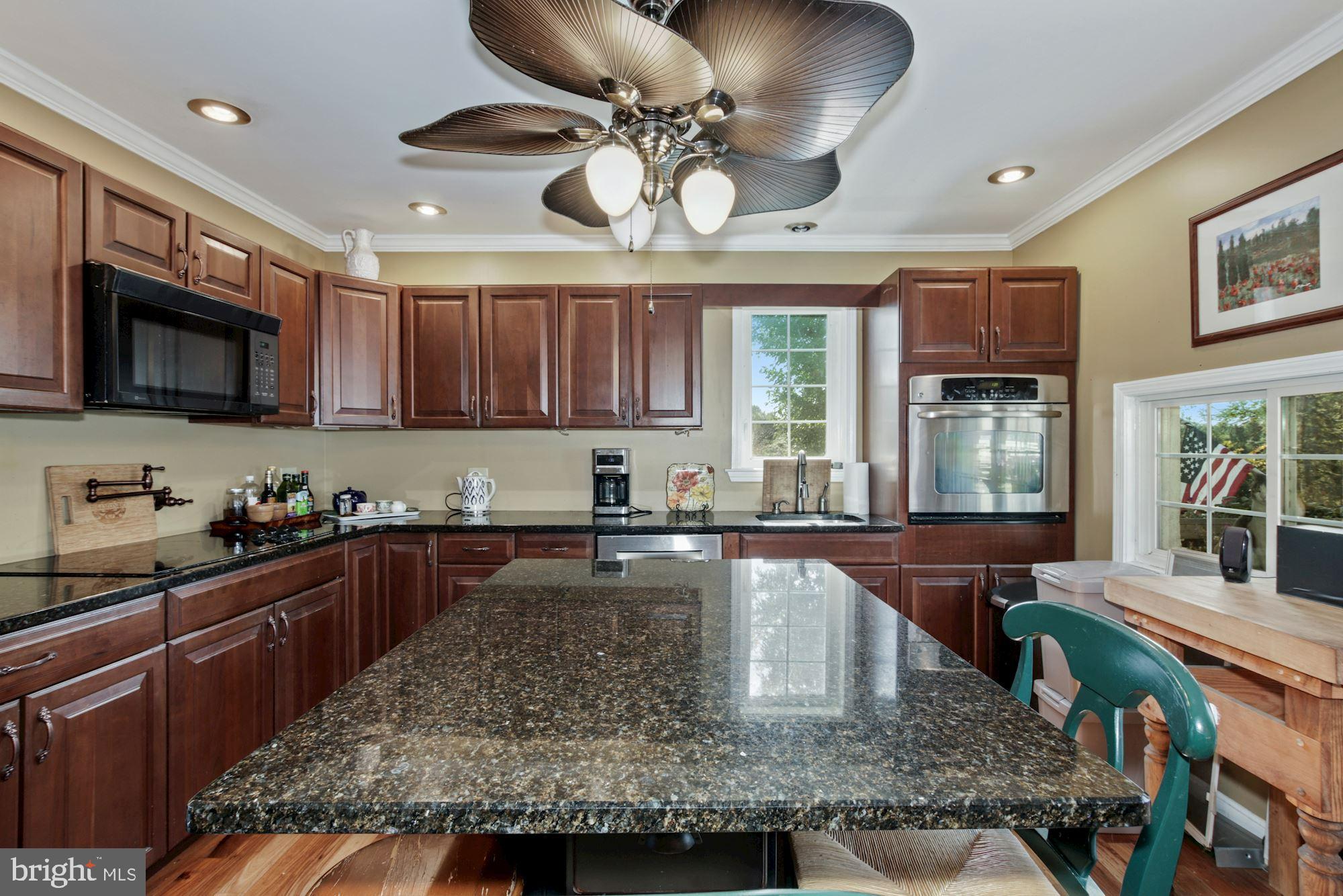 87 Eayrestown Road Medford, NJ 08055 - Photo 12 of 37 a kitchen with stainless steel appliances granite countertop a sink a stove and cabinets