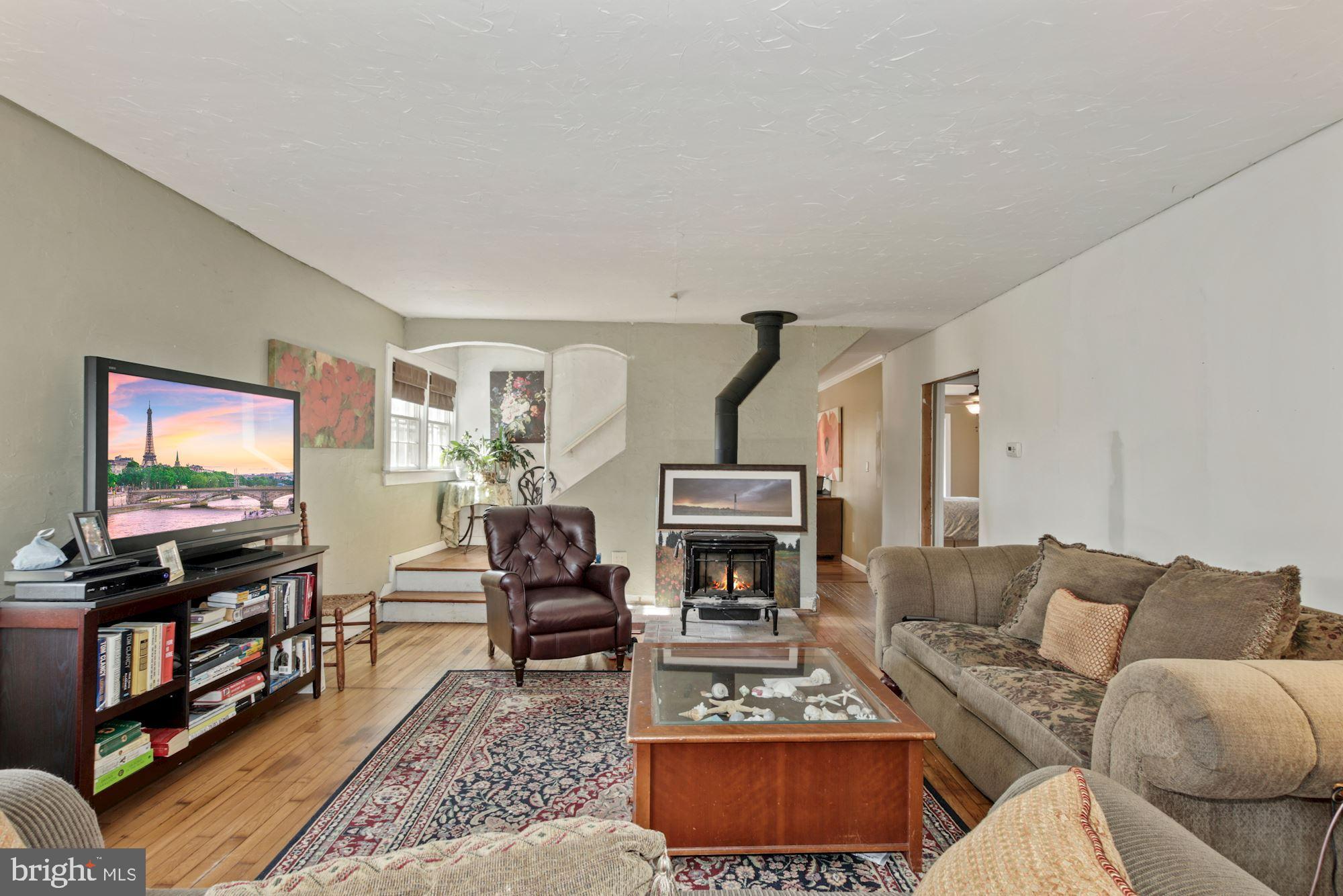 87 Eayrestown Road Medford, NJ 08055 - Photo 15 of 37 a living room with furniture a flat screen tv and a fireplace