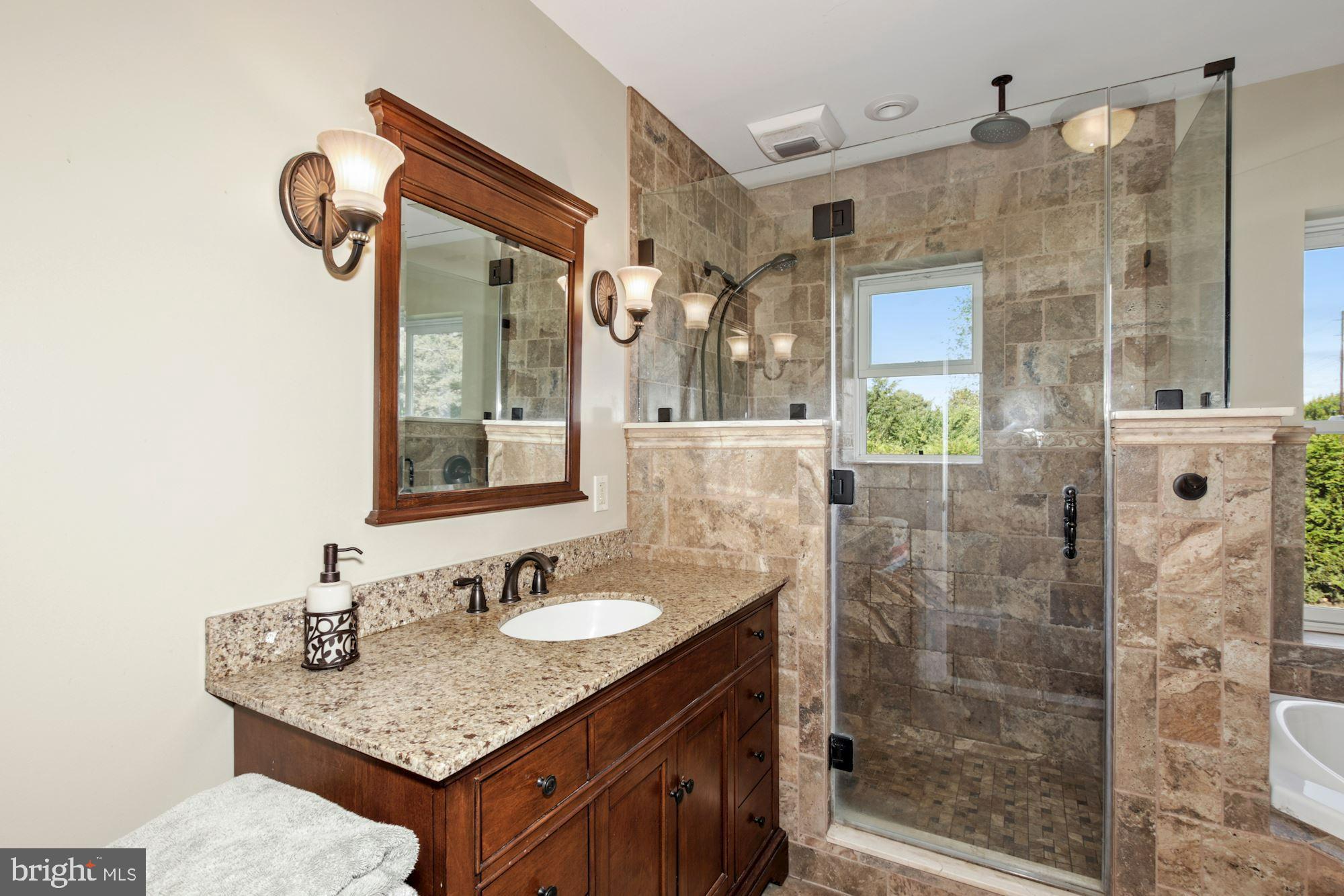87 Eayrestown Road Medford, NJ 08055 - Photo 22 of 37 a bathroom with a granite countertop sink a mirror and a shower