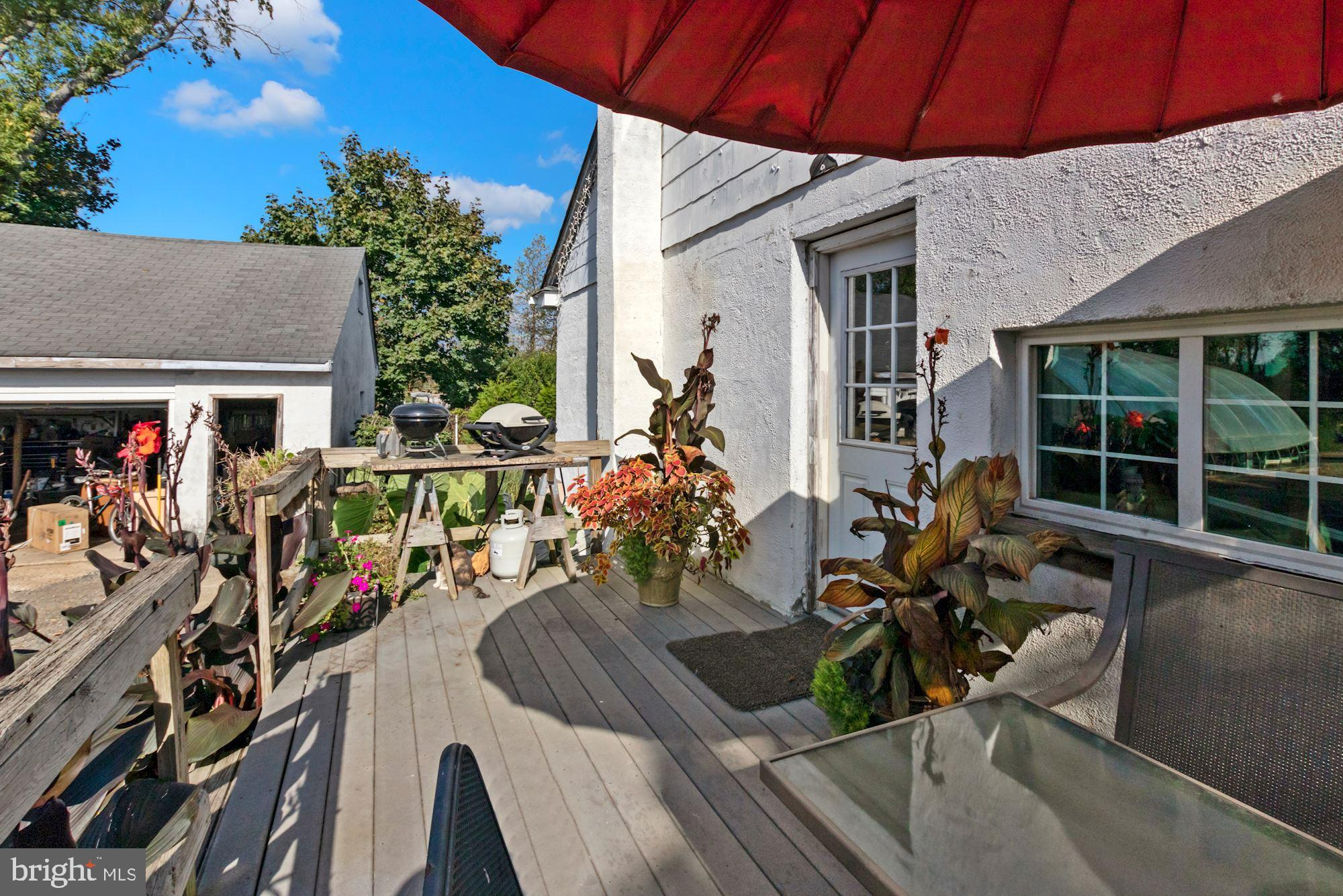 87 Eayrestown Road Medford, NJ 08055 - Photo 10 of 37 a view of a patio with table and chairs potted plants with wooden floor