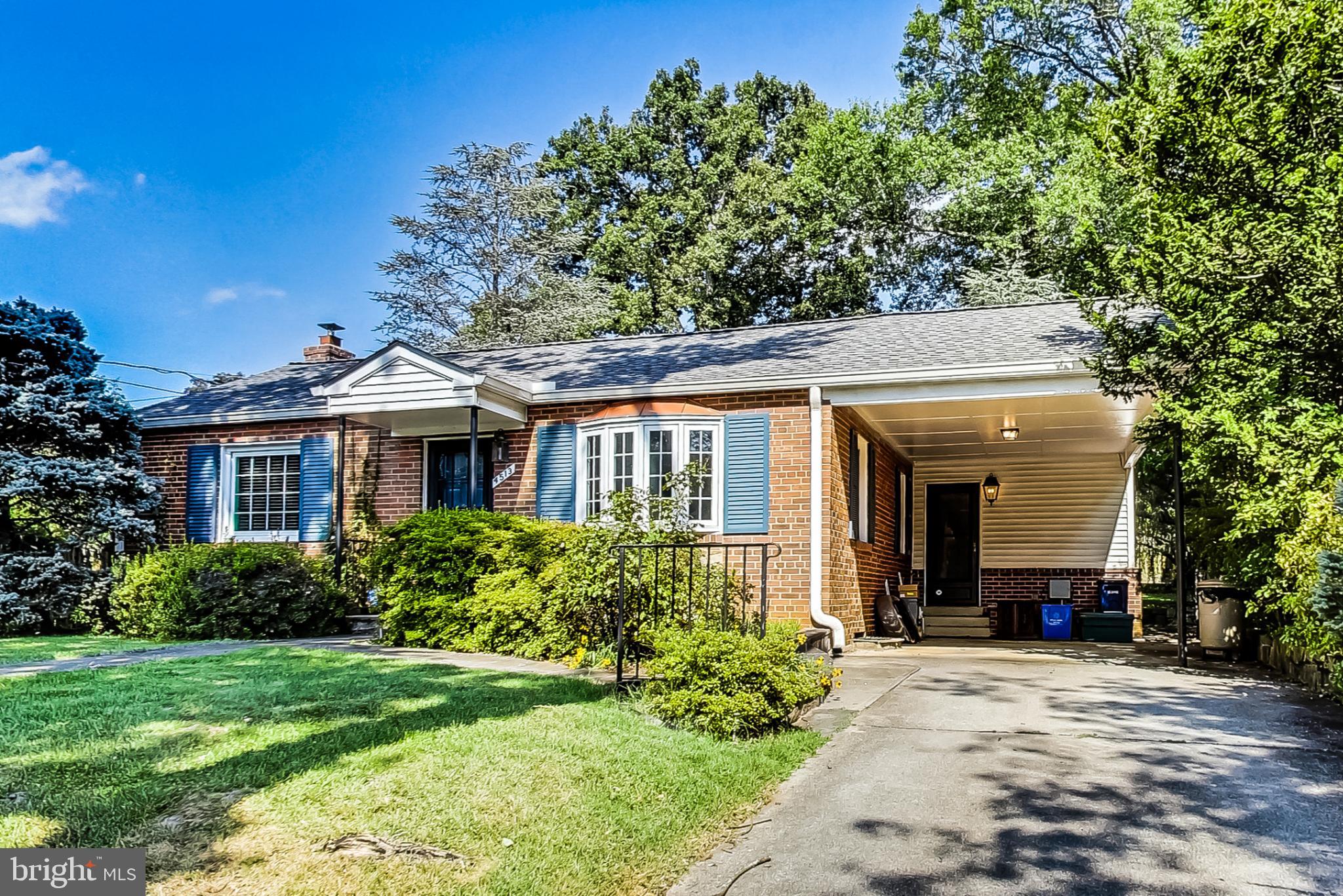 4513 Puller Drive Kensington, MD 20895 - Photo 13 of 46 a front view of a house with a yard and potted plants