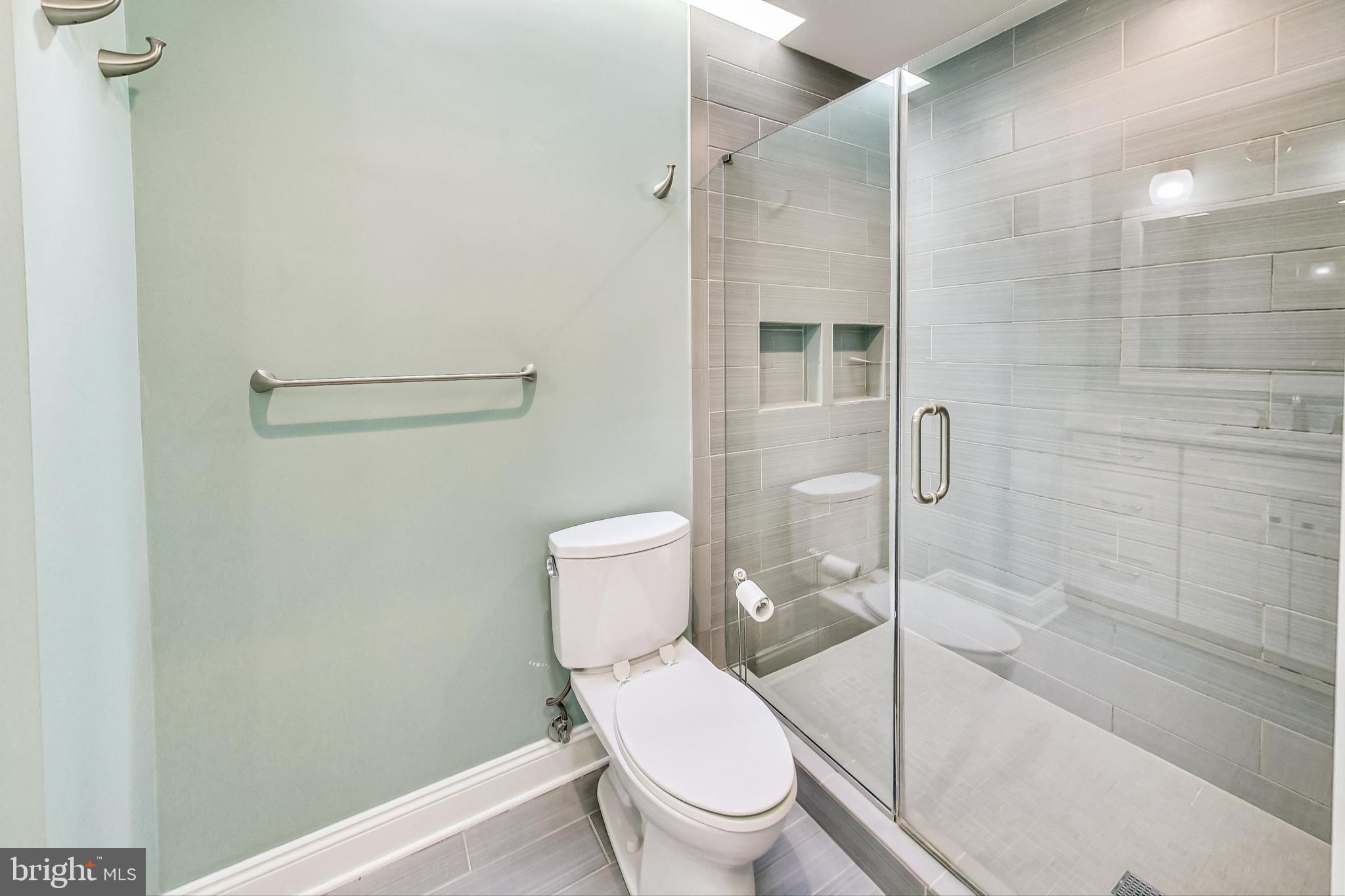 4513 Puller Drive Kensington, MD 20895 - Photo 26 of 46 a white toilet sitting next to a bath tub and shower