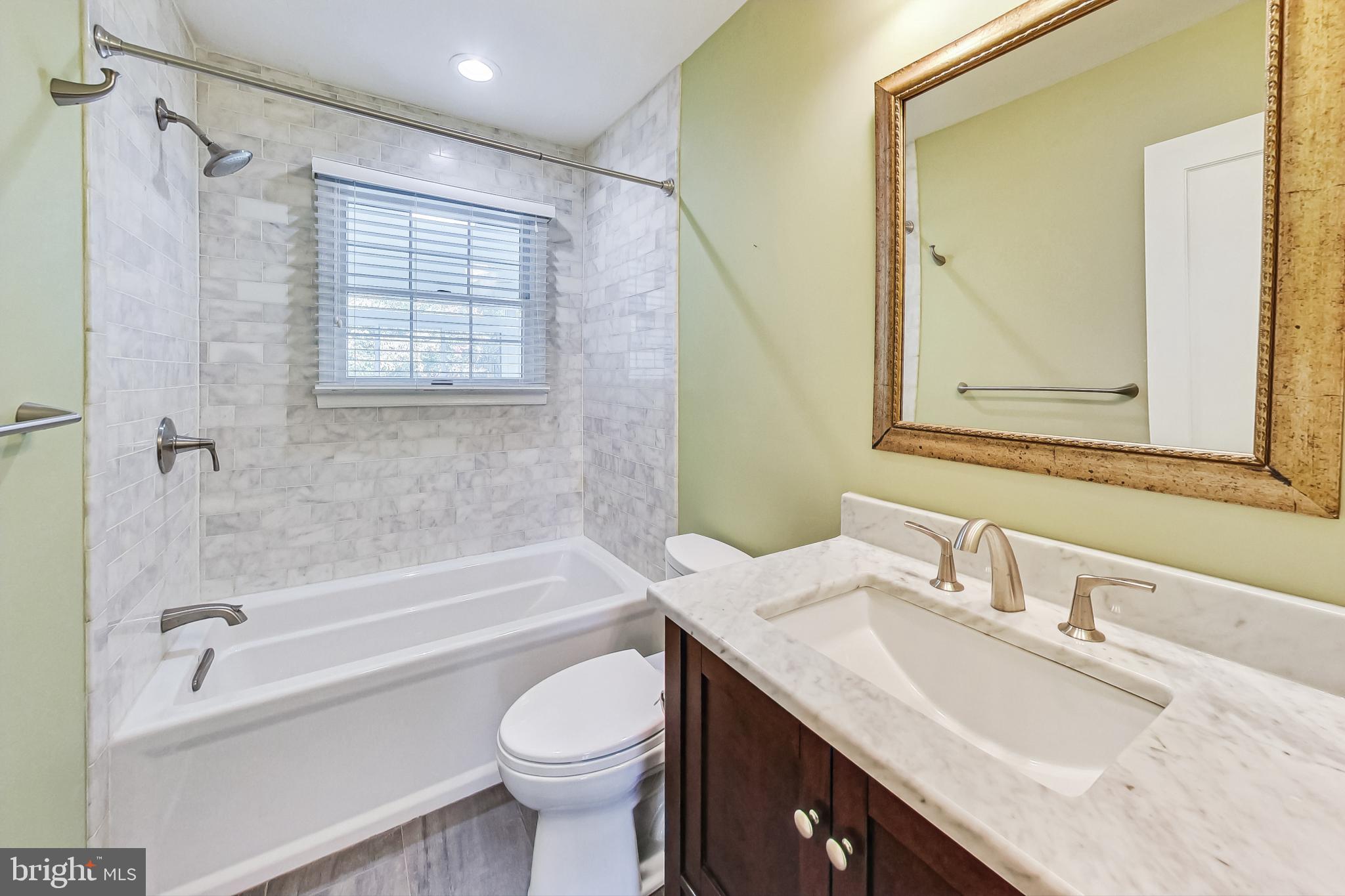 4513 Puller Drive Kensington, MD 20895 - Photo 29 of 46 a bathroom with a granite countertop sink toilet and shower