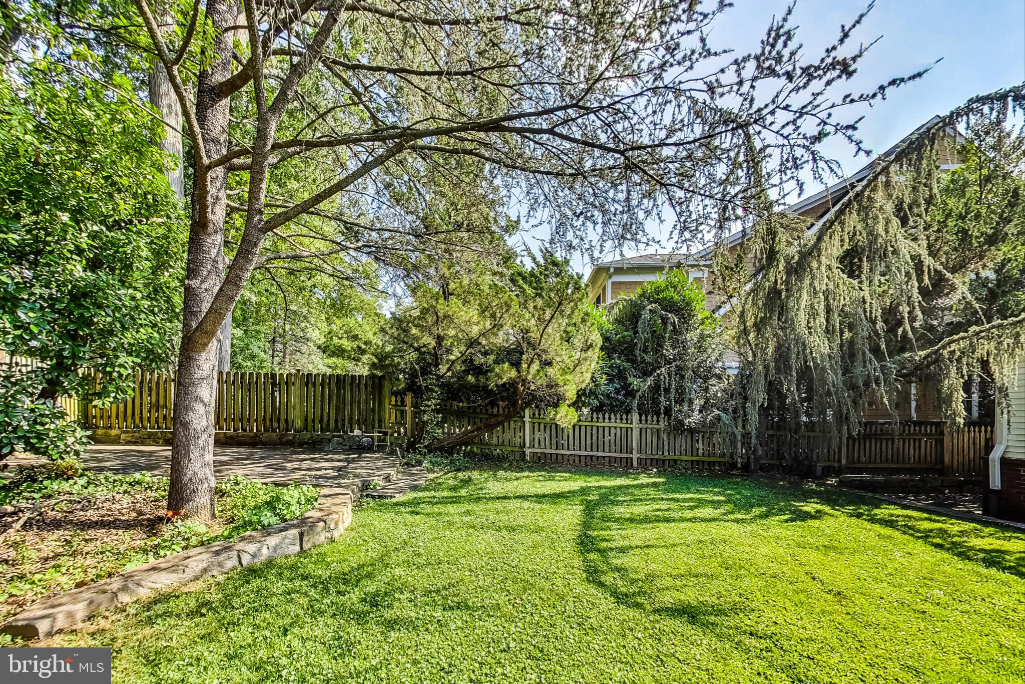 4513 Puller Drive Kensington, MD 20895 - Photo 44 of 46 a backyard of a house with lots of green space and fountain