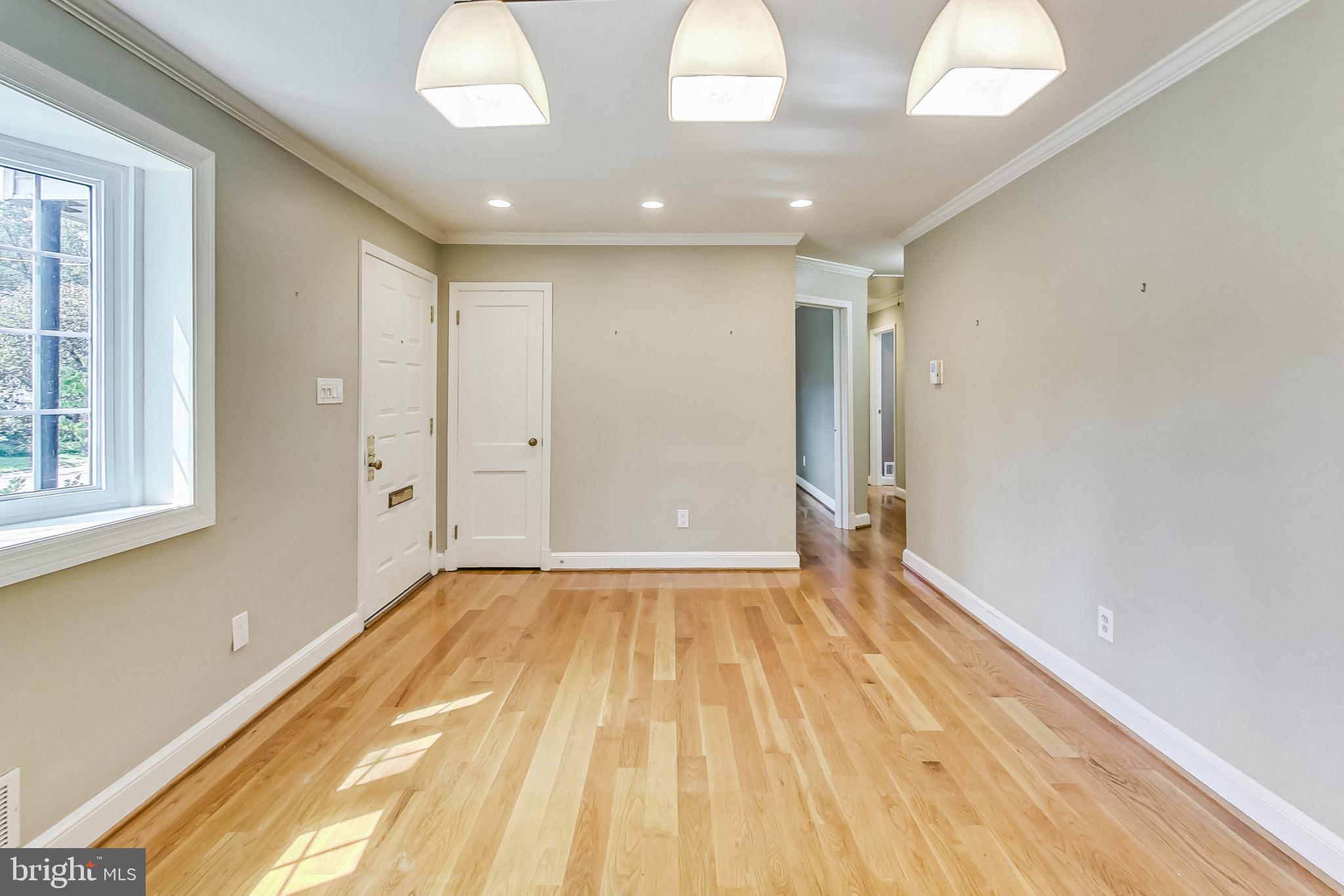 4513 Puller Drive Kensington, MD 20895 - Photo 6 of 46 a view of an empty room with wooden floor and a window