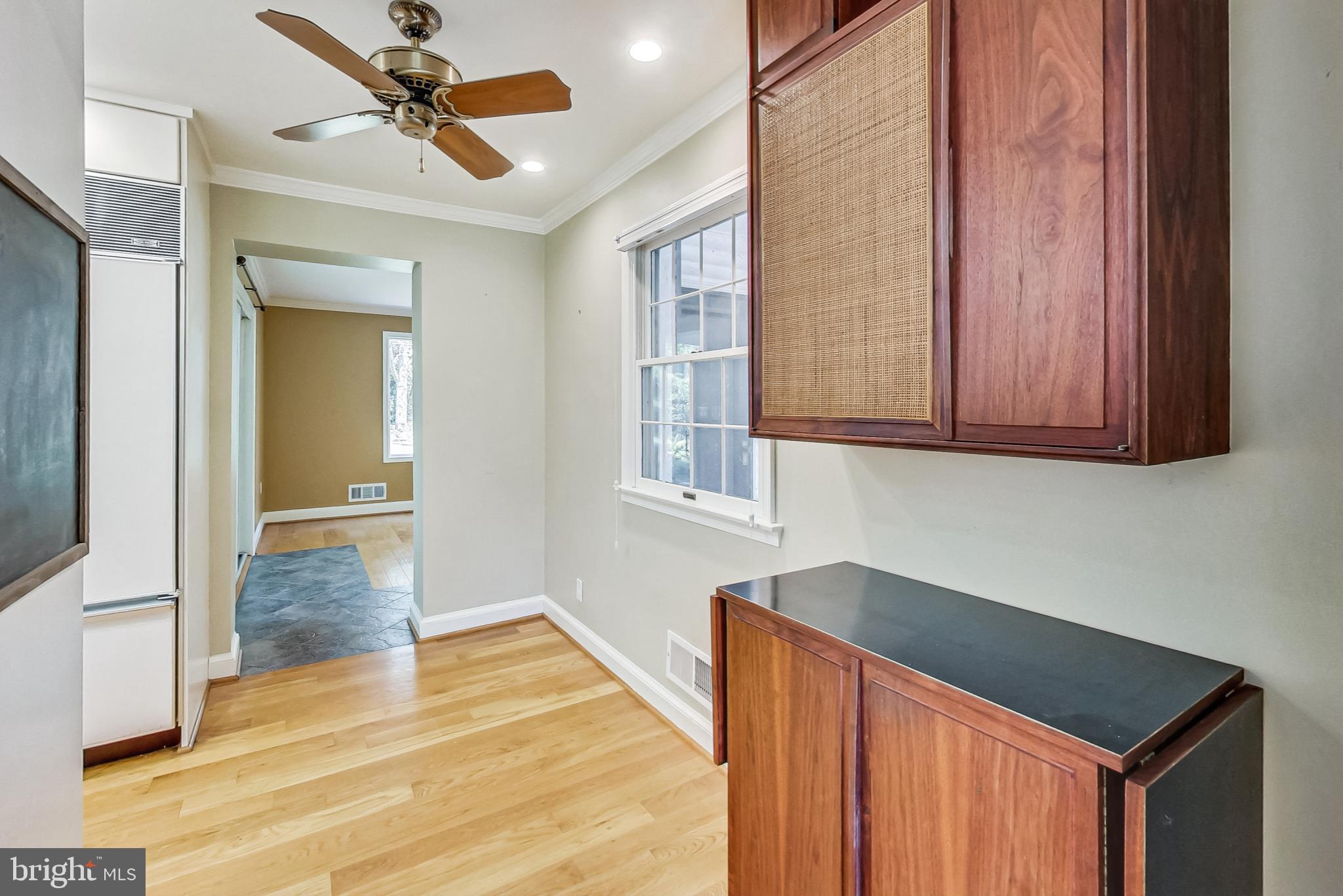 4513 Puller Drive Kensington, MD 20895 - Photo 10 of 46 a hallway with wooden floor and chandelier