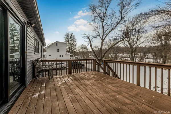 a view of balcony with wooden floor and fence