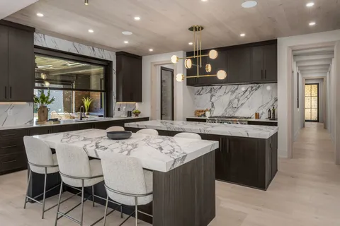 a kitchen with center island table and chairs in it