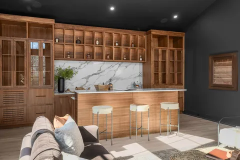 a large bedroom with a bed and large windows