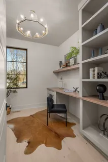 a living room with furniture and a floor to ceiling window