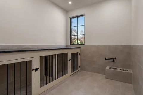 a patio with table and chairs and potted plants