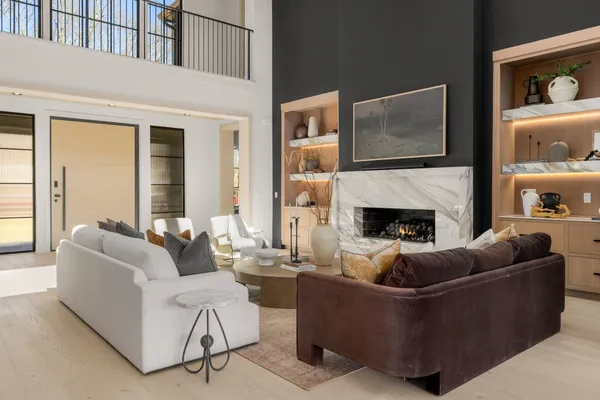a living room with furniture large window and flat screen tv