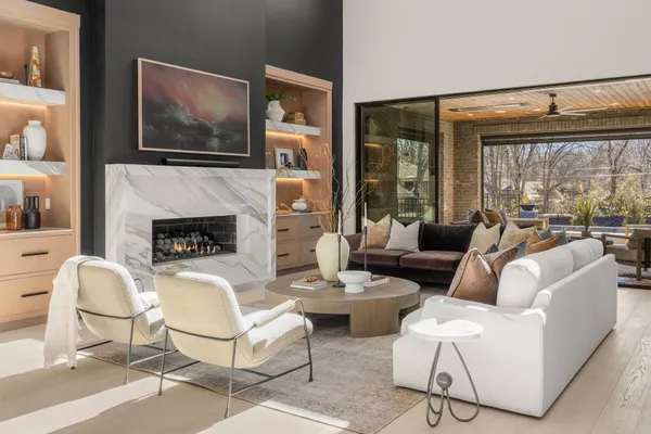a living room with furniture a flat screen tv and a fireplace