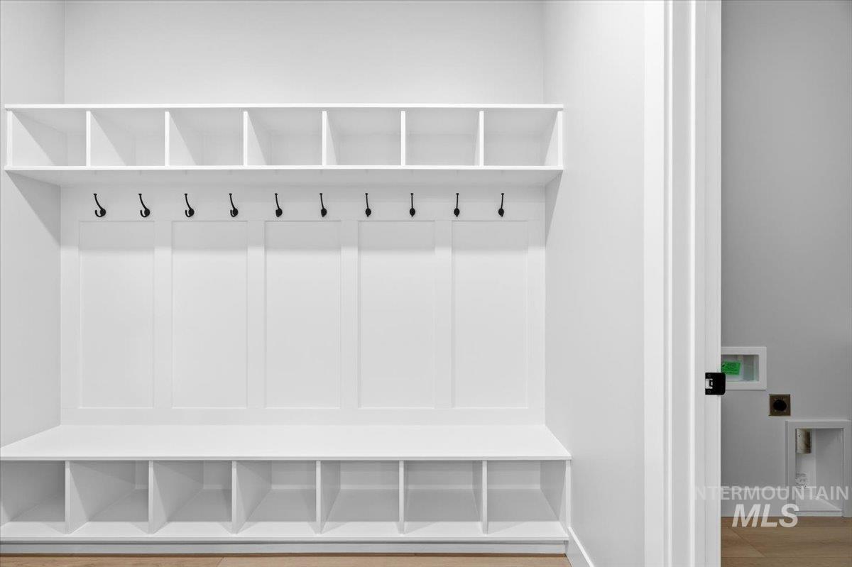 4317 Tropic Way Caldwell, ID 83607 - Photo 37 of 47 Mudroom featuring built-in cubbies with individual compartments, integrated hooks for coats and accessories, and a lower bench with storage cubbies