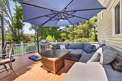 a view of a house with a yard and sitting area
