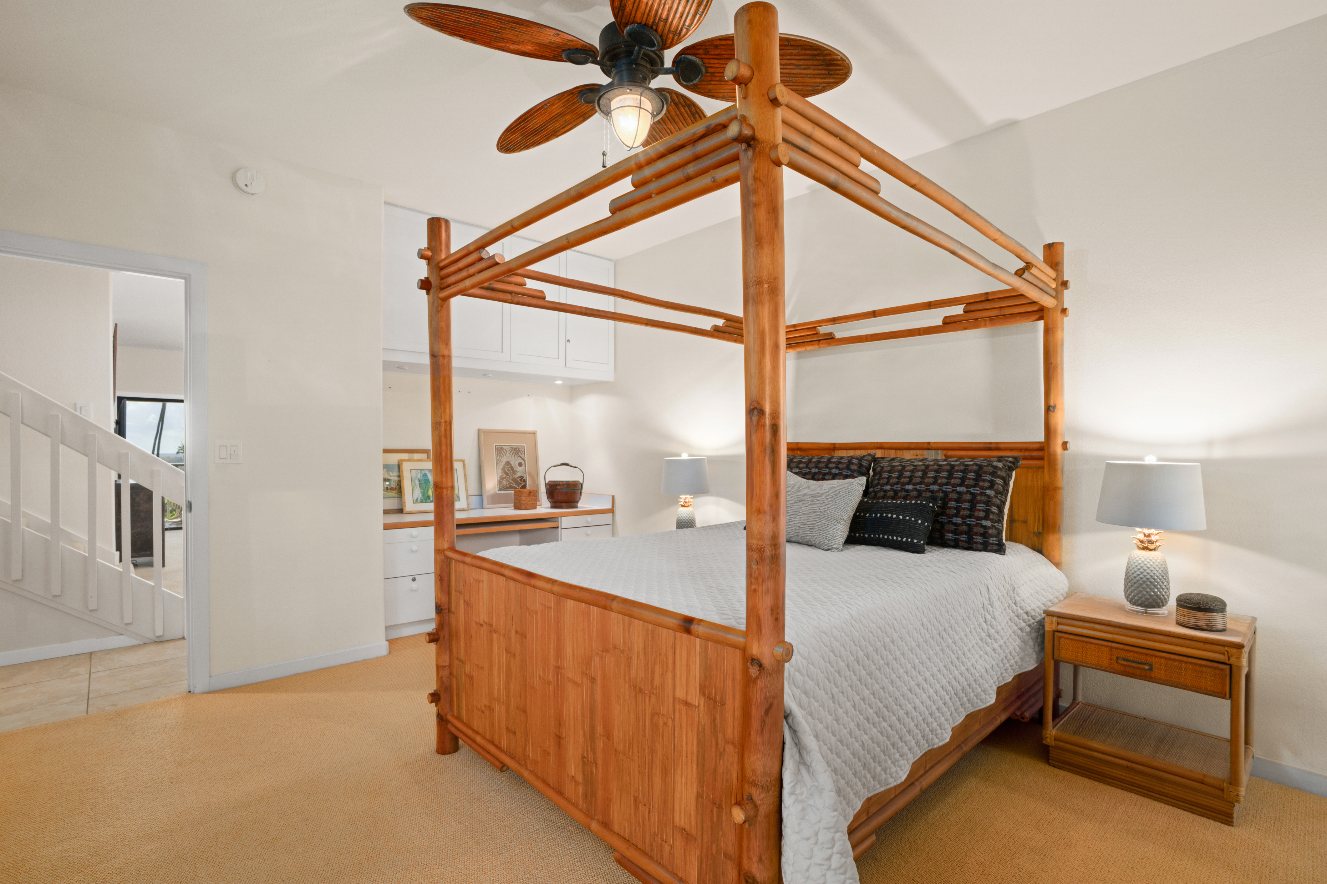 1565 Pe'e Road, Unit 125 Koloa, HI 96756 - Photo 11 of 20 a bedroom with a bed and a chandelier