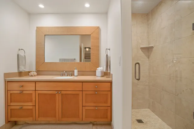 a bathroom with a granite countertop sink a mirror and a