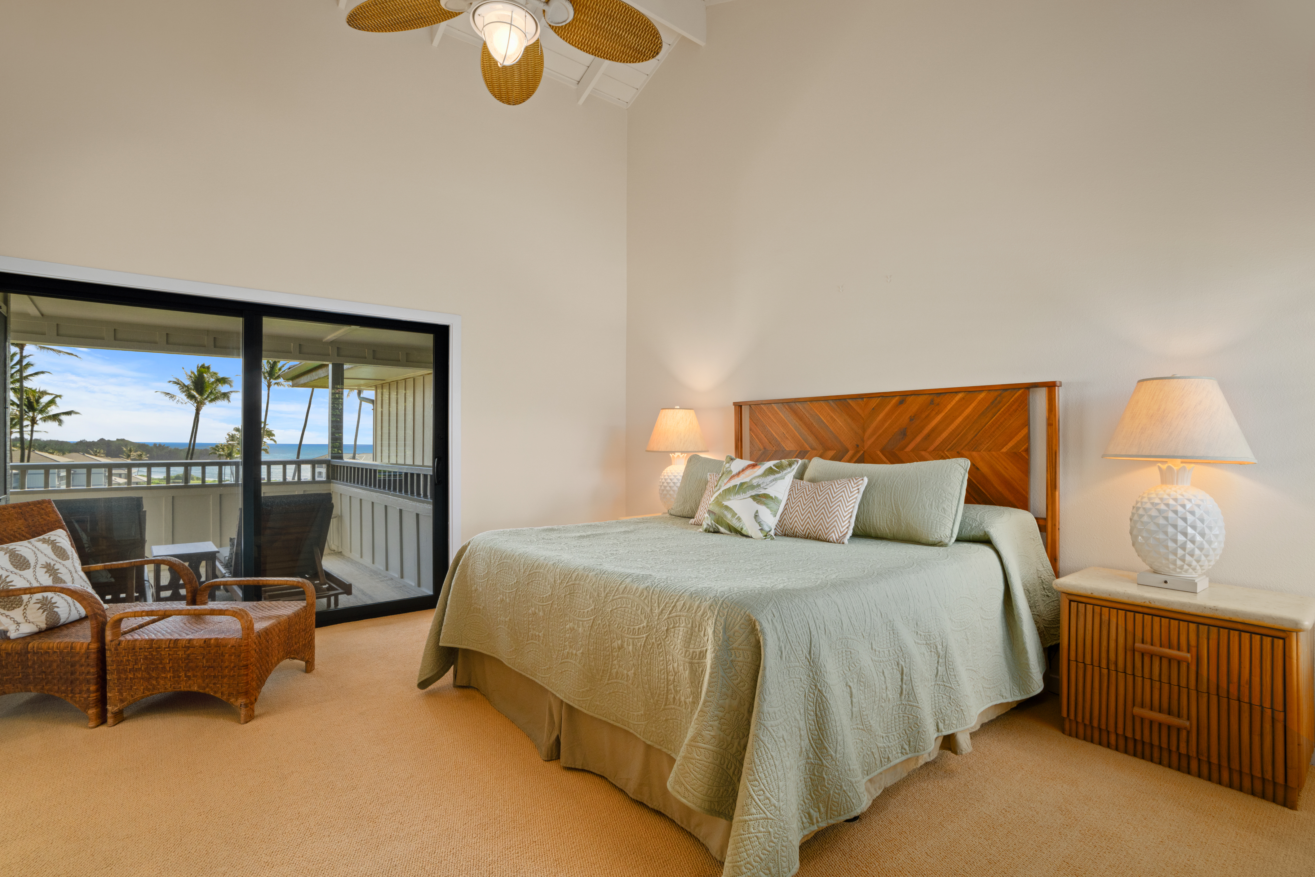 1565 Pe'e Road, Unit 125 Koloa, HI 96756 - Photo 14 of 20 a bedroom with a bed and glass window