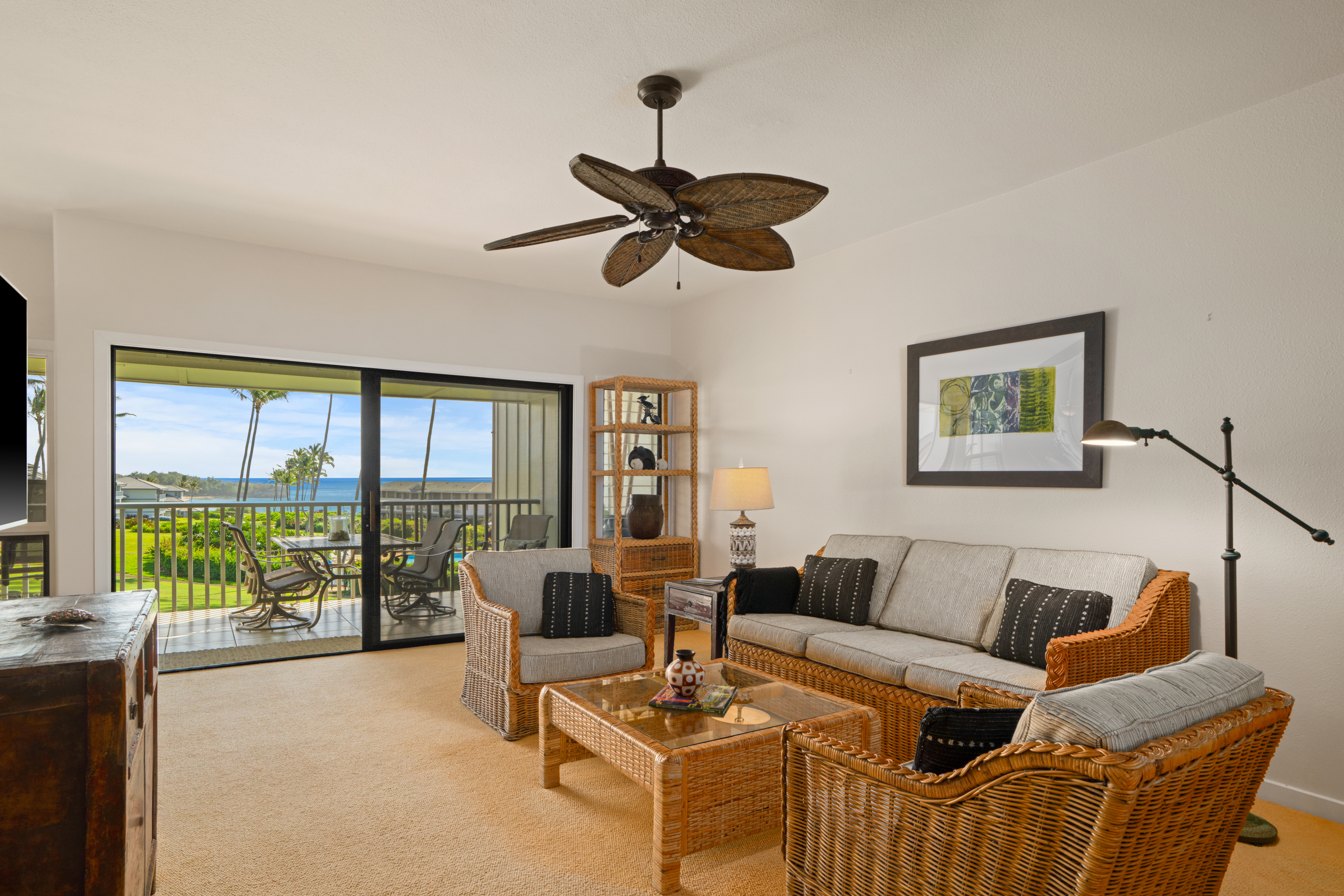 1565 Pe'e Road, Unit 125 Koloa, HI 96756 - Photo 2 of 20 a living room with furniture and a large window