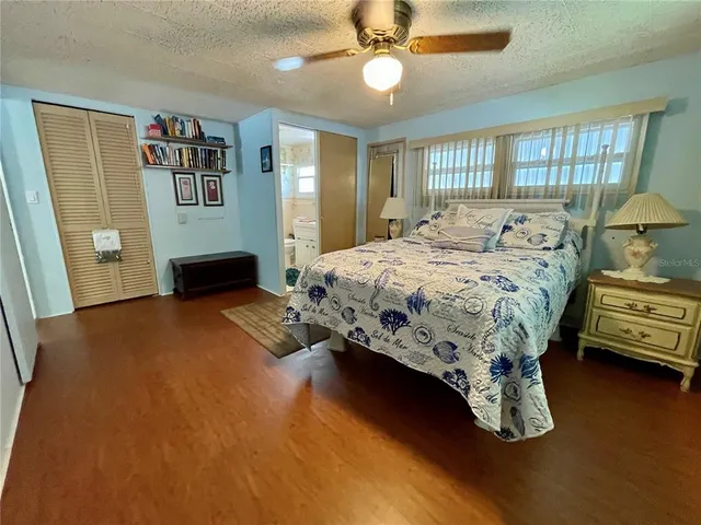 a bedroom with a bed and dresser with window