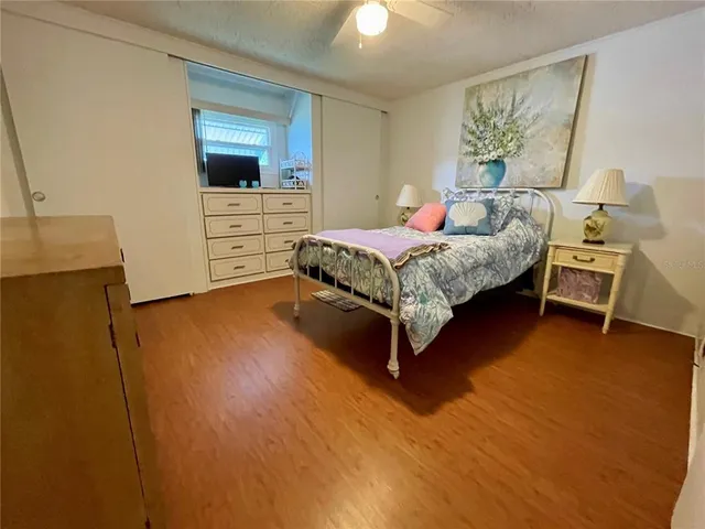 a spacious bedroom with a bed and a flat screen tv