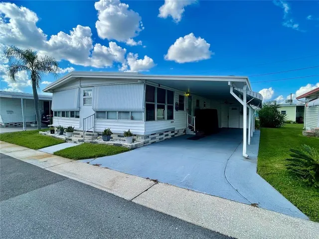 a view of a house with a backyard porch and sitting area