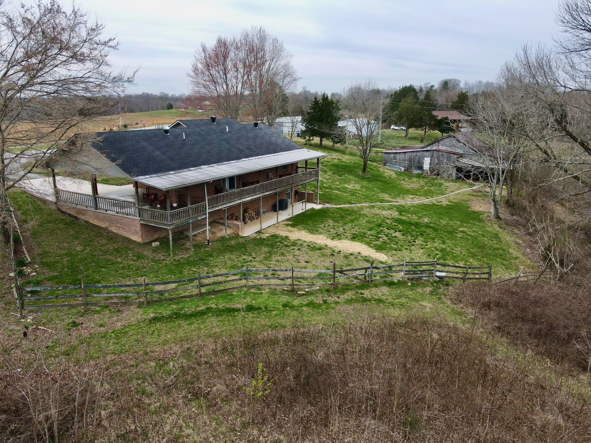 9567 Barnes Ridge Road Monroe, TN 38573 - Photo 9 of 56 a aerial view of a house with a yard table and chairs