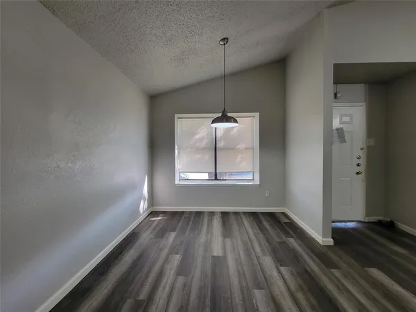 a view of room with window wooden floor and ceiling fan