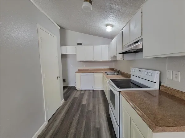 a kitchen with wooden cabinets and a sink