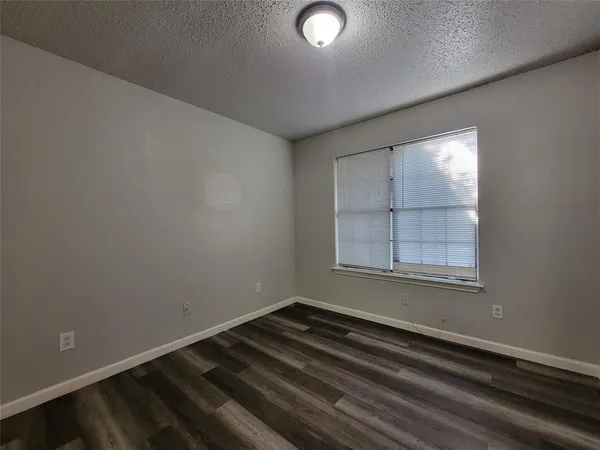 an empty room with a empty space and windows