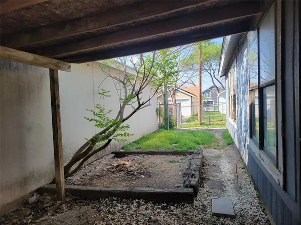 a view of a porch with plants and a potted plant