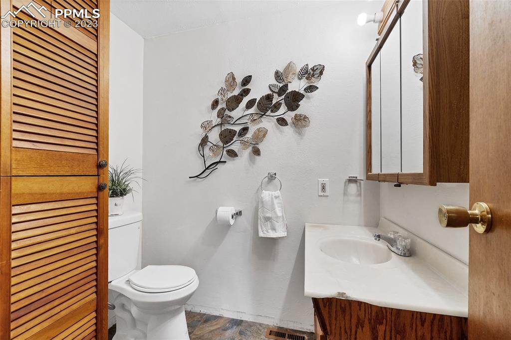 1128 Alexander Road Colorado Springs, CO 80909 - Photo 16 of 26 a bathroom with a sink toilet and shower