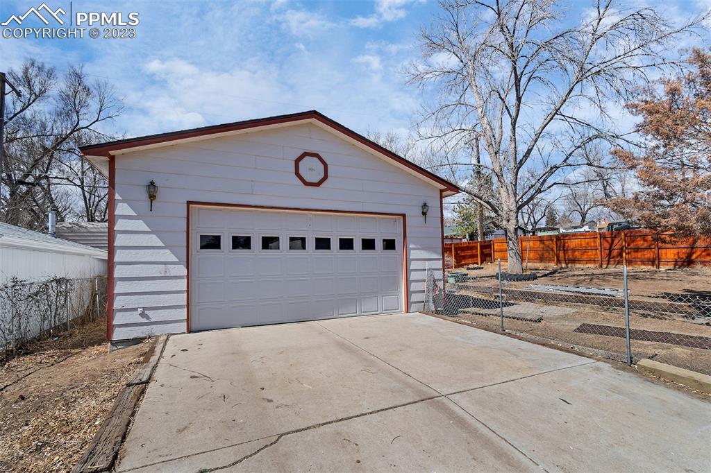 1128 Alexander Road Colorado Springs, CO 80909 - Photo 17 of 26 a front view of a building with trees