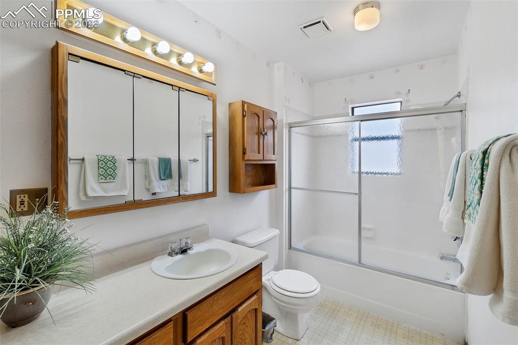1128 Alexander Road Colorado Springs, CO 80909 - Photo 10 of 26 a bathroom with a sink toilet and shower