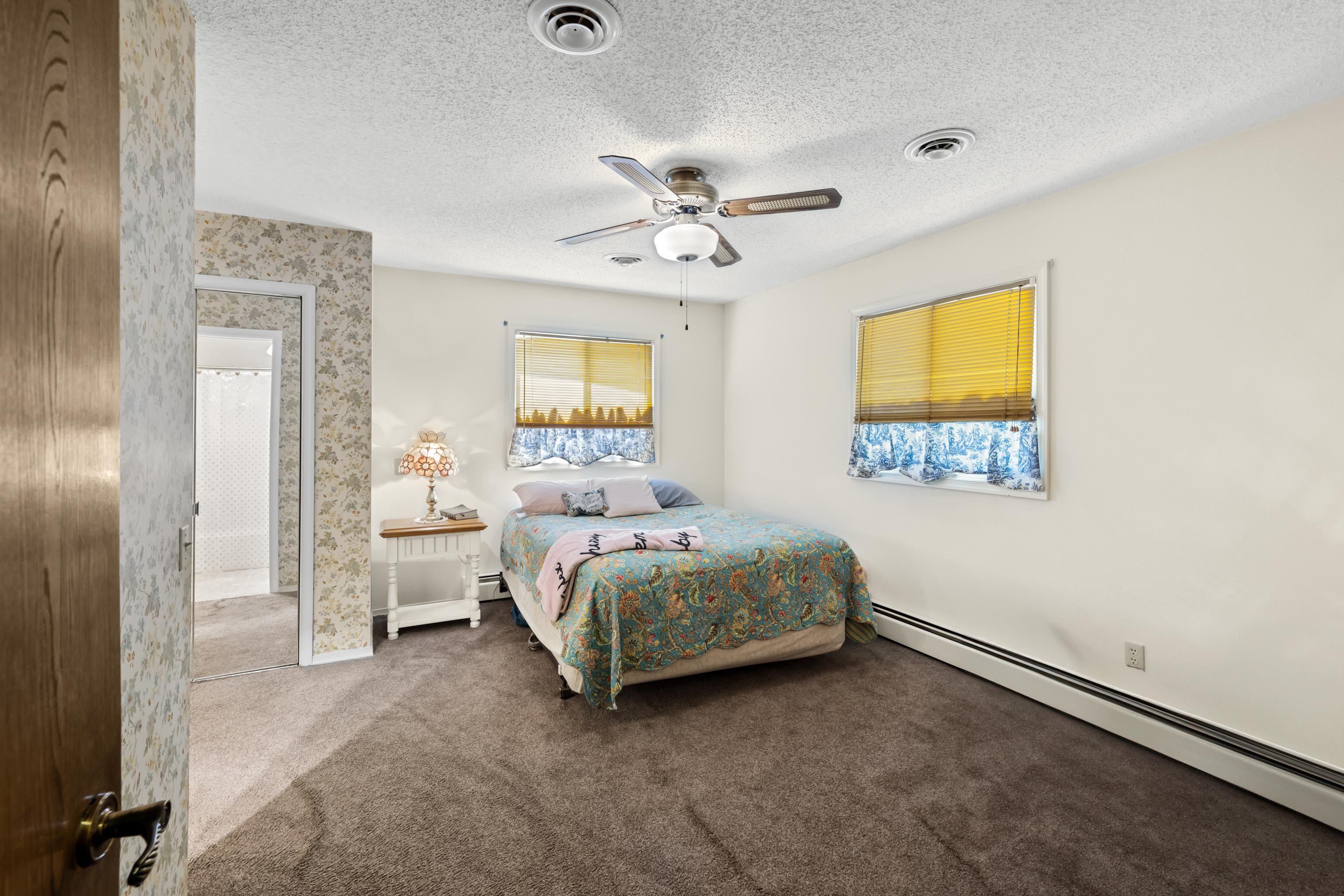 2059 Old Greenville Road Staunton, VA 24401 - Photo 26 of 60 a bedroom with a bed and a chandelier