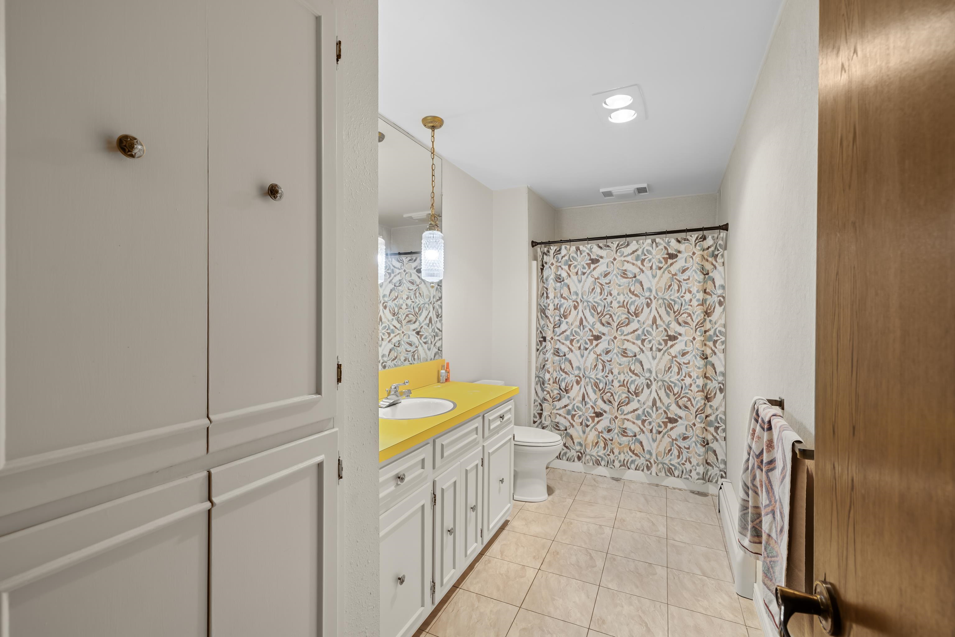 2059 Old Greenville Road Staunton, VA 24401 - Photo 40 of 60 a bathroom with a granite countertop sink a mirror and a bathtub