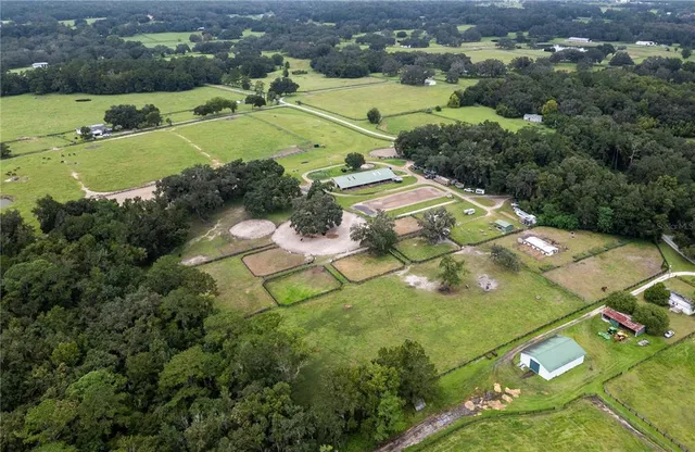 an aerial view of a residential houses with outdoor space