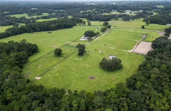 an aerial view of a houses with yard