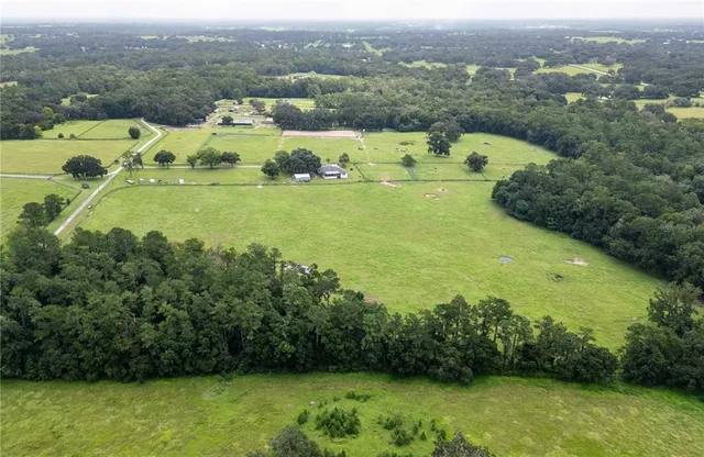an aerial view of a houses with a lake view