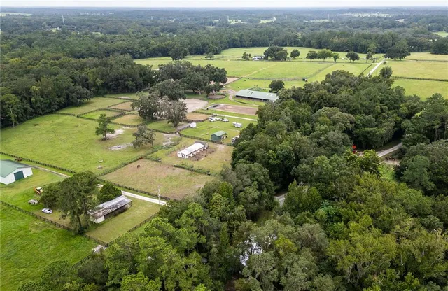 an aerial view of a houses with a lake view