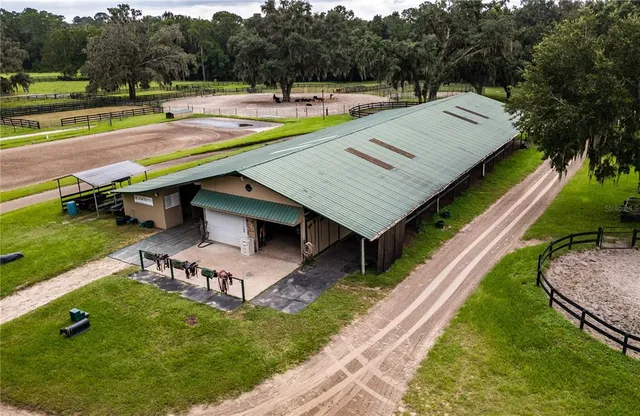 an aerial view of a house with swimming pool garden and patio