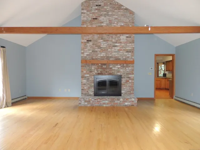 a view of an empty room with a fireplace
