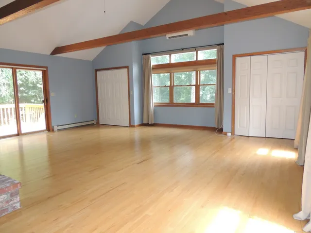 a view of an empty room with glass door