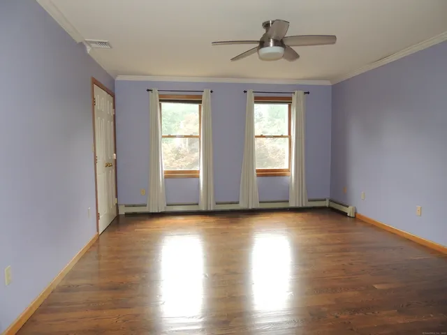 a view of room with window and wooden floor
